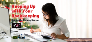 Woman sitting at desk keeping up with bookkeeping during the holiday season